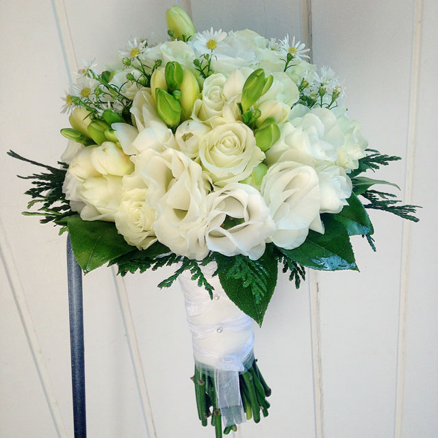 Ramo de novia en tonos blancos compuesto con rosas blancas, freesia y tanacetum